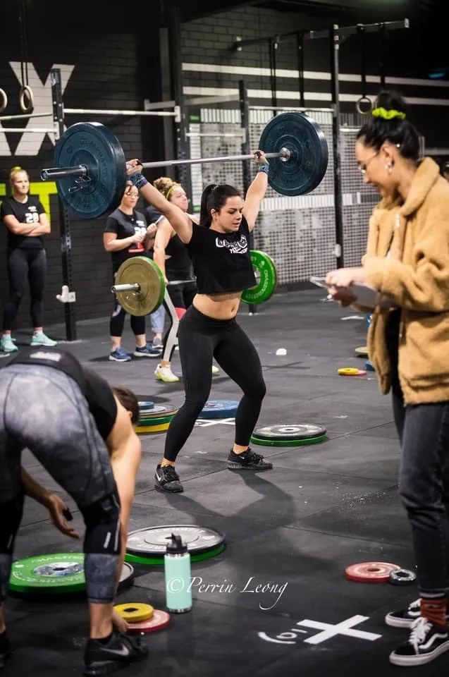 Offset athletes performing olympic snatch during competition