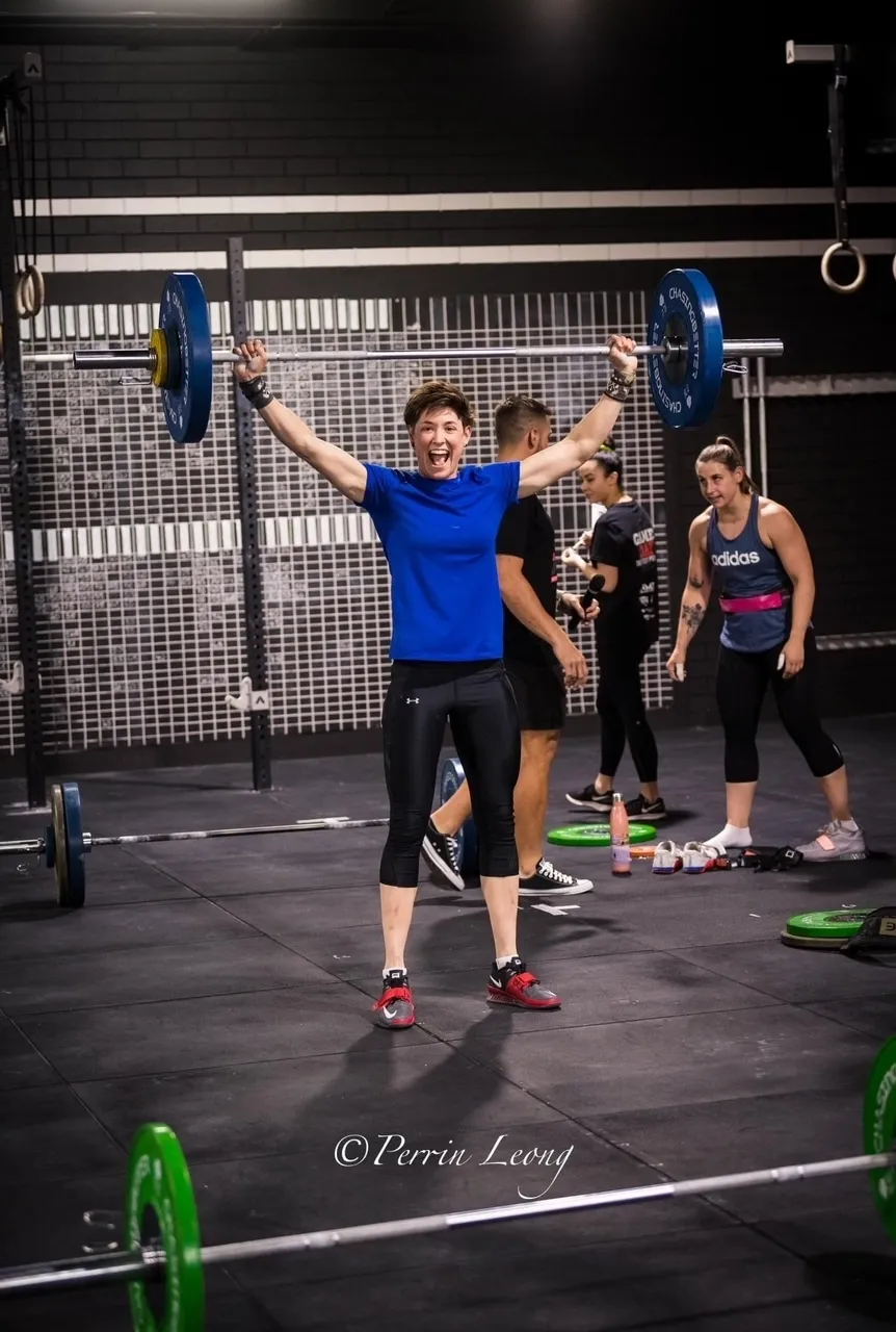 Offset athlete performing snatch during competition