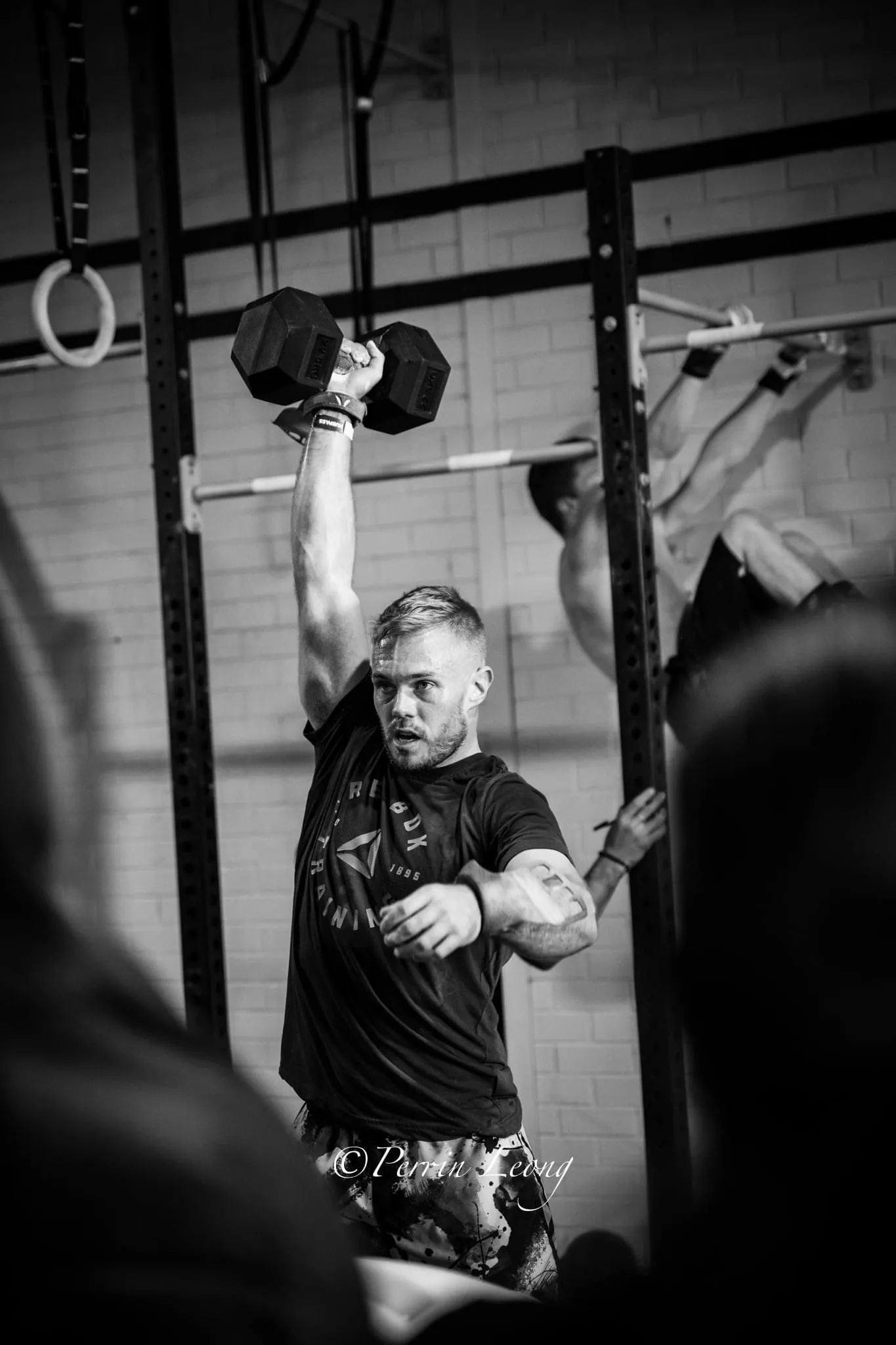 Offset athlete performing dumbell snatch