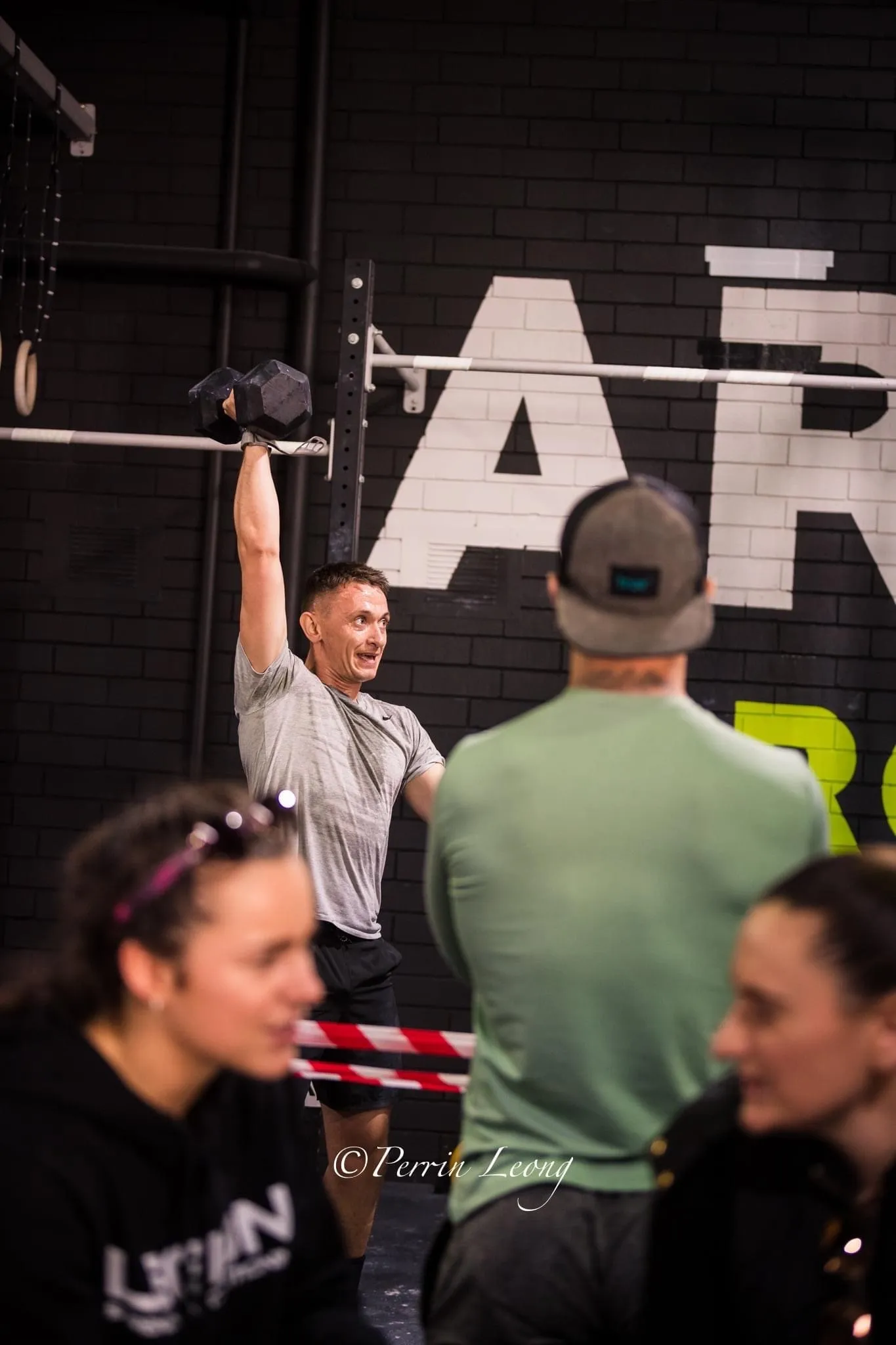 Offset athlete performing dumbell snatch