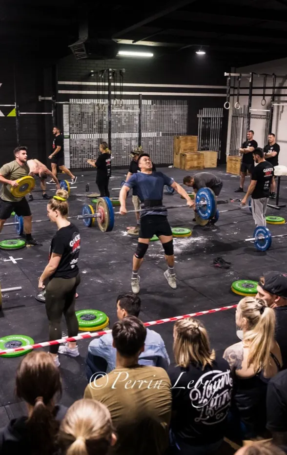 Offset athlete performing snatch during competition