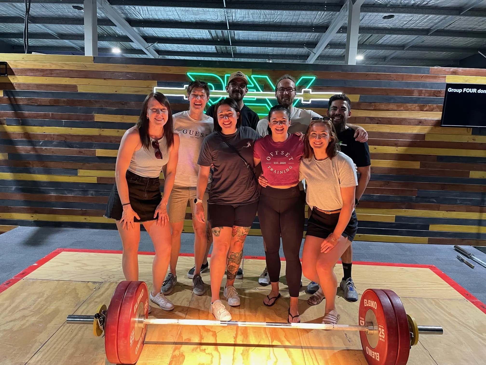 Offset crew posing on weightlifting platform